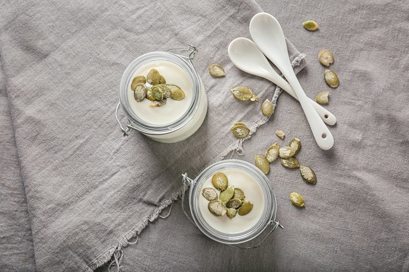 yogurt-with-pumpkin-seeds-in-jars-on-fabric